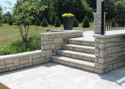 Expertly-landscaped LawnScapes outdoor project with decorative plants and stonework.