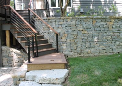 Expertly-landscaped LawnScapes outdoor project with decorative plants and stonework.