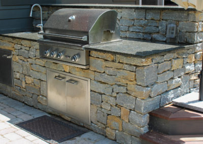 Expertly-landscaped LawnScapes outdoor project with decorative plants and stonework.