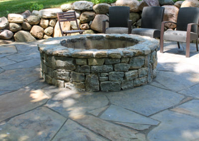 Expertly-landscaped LawnScapes outdoor project with decorative plants and stonework.