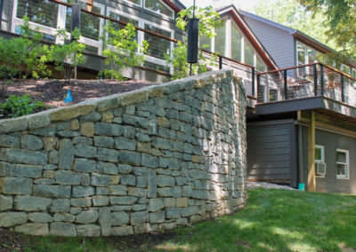 Expertly-landscaped LawnScapes outdoor project with decorative plants and stonework.