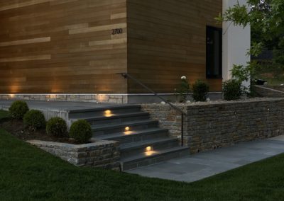 Expertly-landscaped LawnScapes outdoor project with decorative plants and stonework.