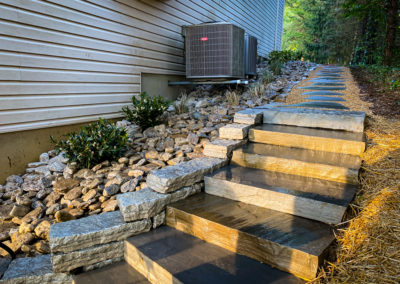 Expertly-landscaped LawnScapes outdoor project with decorative plants and stonework.