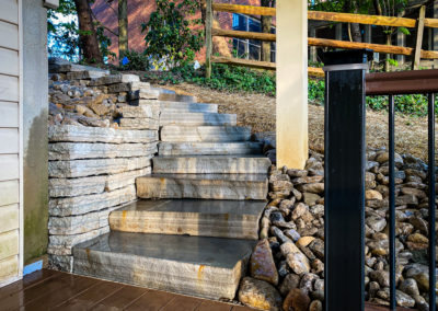 Expertly-landscaped LawnScapes outdoor project with decorative plants and stonework.