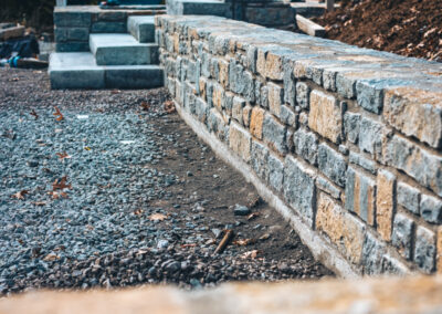 Expertly-landscaped LawnScapes outdoor project with decorative plants and stonework.