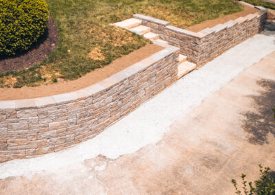 Expertly-landscaped LawnScapes outdoor project with decorative plants and stonework.