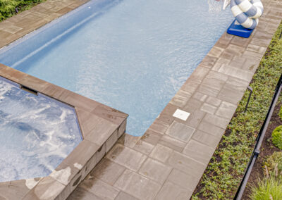 Expertly-landscaped LawnScapes outdoor project with decorative plants and stonework.
