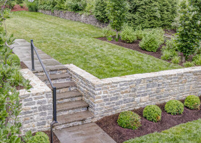 Expertly-landscaped LawnScapes outdoor project with decorative plants and stonework.