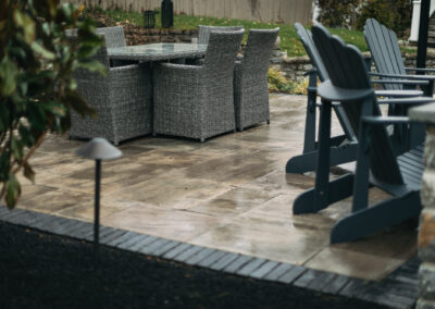 Expertly-landscaped LawnScapes outdoor project with decorative plants and stonework.