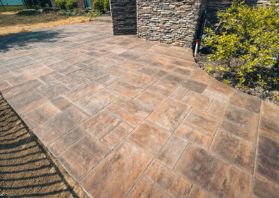 Expertly-landscaped LawnScapes outdoor project with decorative plants and stonework.