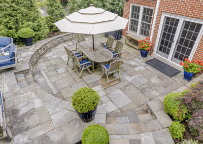 Expertly-landscaped LawnScapes outdoor project with decorative plants and stonework.