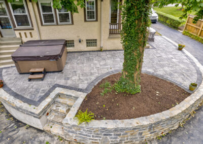 Expertly-landscaped LawnScapes outdoor project with decorative plants and stonework.