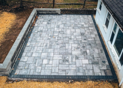 Expertly-landscaped LawnScapes outdoor project with decorative plants and stonework.