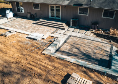 Expertly-landscaped LawnScapes outdoor project with decorative plants and stonework.