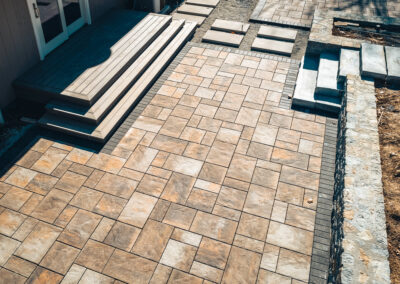 Expertly-landscaped LawnScapes outdoor project with decorative plants and stonework.