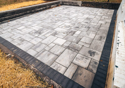 Expertly-landscaped LawnScapes outdoor project with decorative plants and stonework.